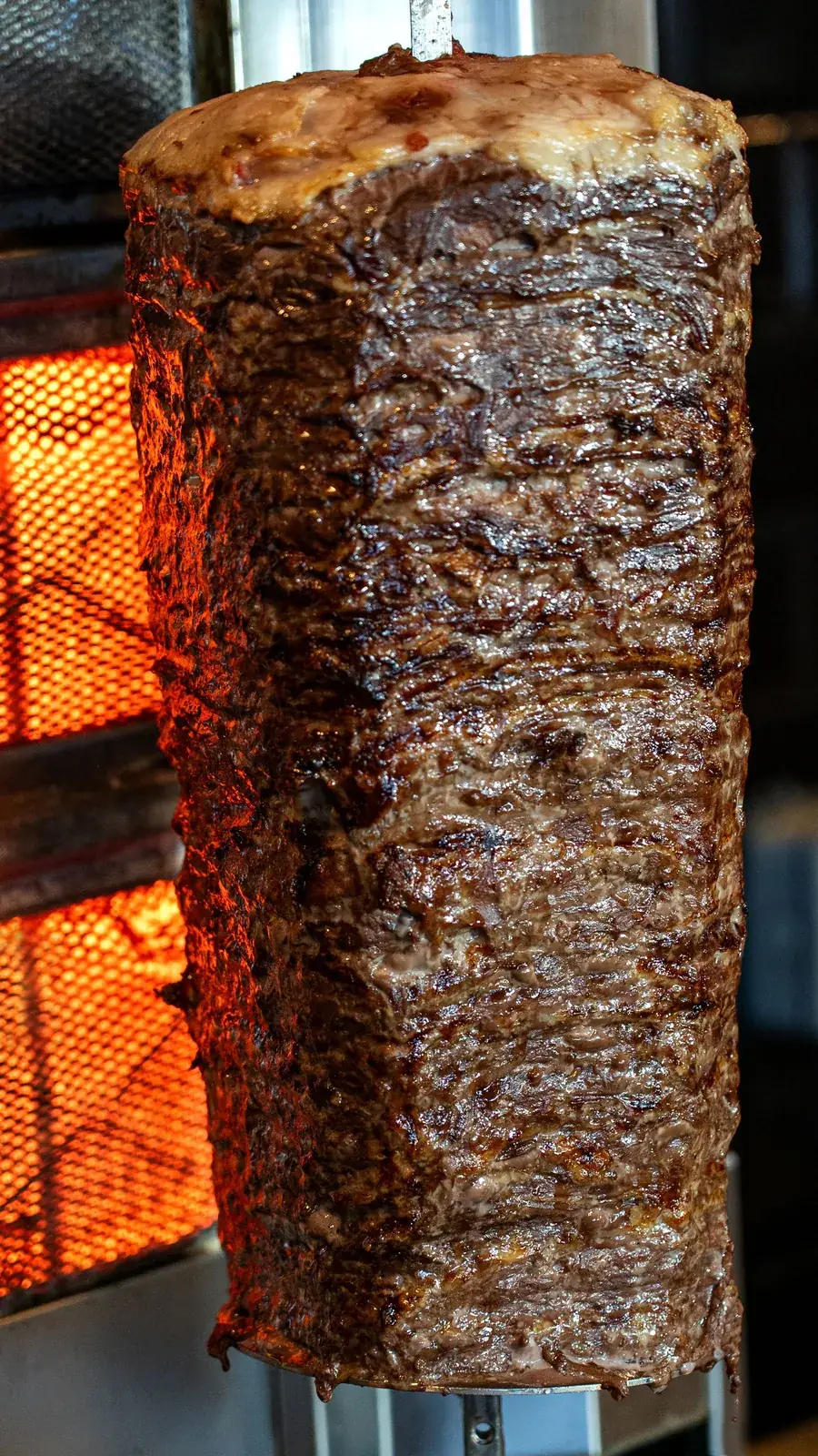 Beef shawarma roasting on the vertical spit